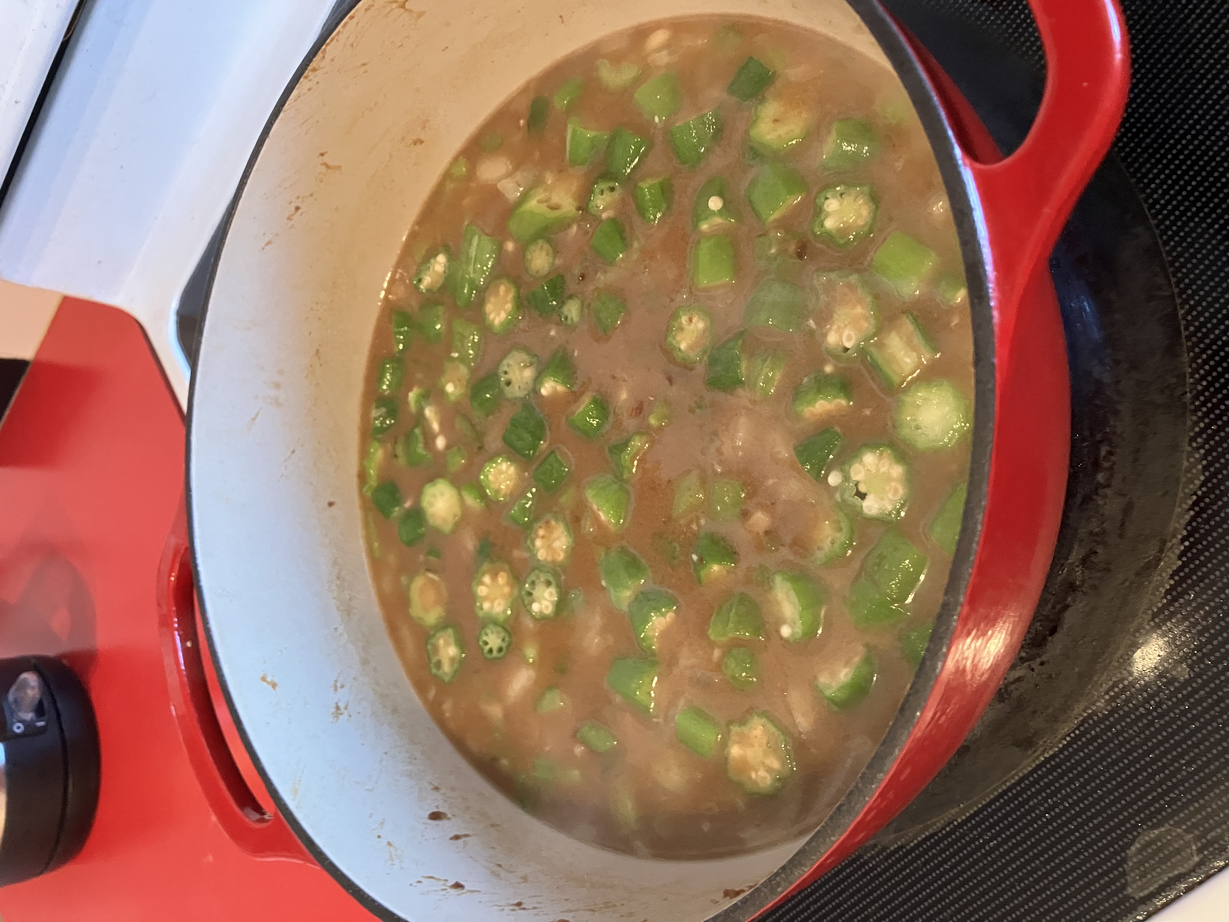 Gumbo in a dutch oven, just before bringing it to a simmer